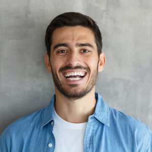 young-man-smiles-broadly-shows-white-perfect-teeth.jpg young-man-smiles-broadly-shows-white-perfect-teeth.jpg